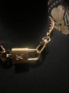 Louis Vuitton Gold lock, and key with unbranded necklace